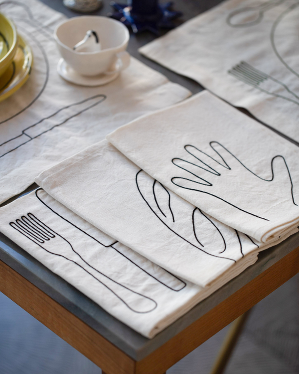 Styled image of Œuvres Sensibles napkins and placemats.