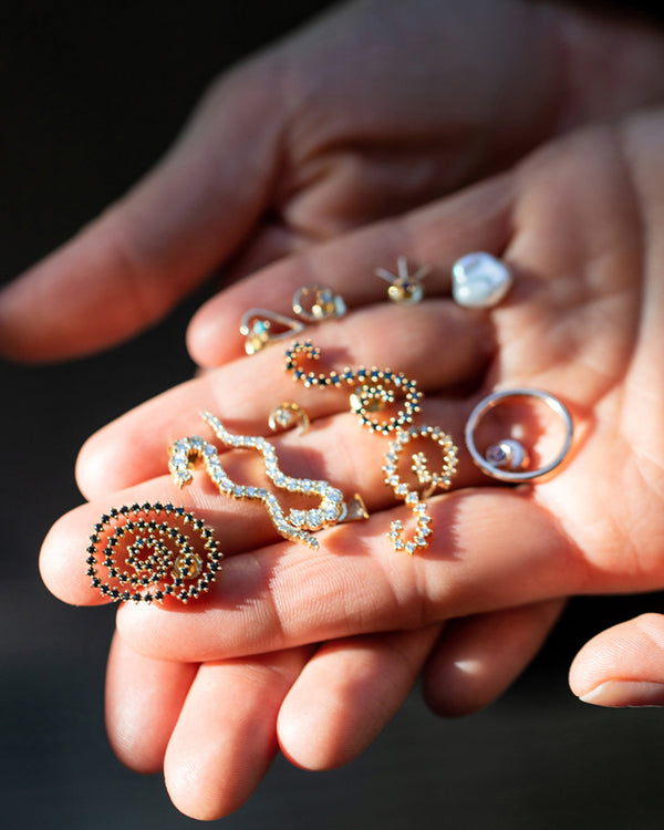 Mociun fine jewelry in hand.