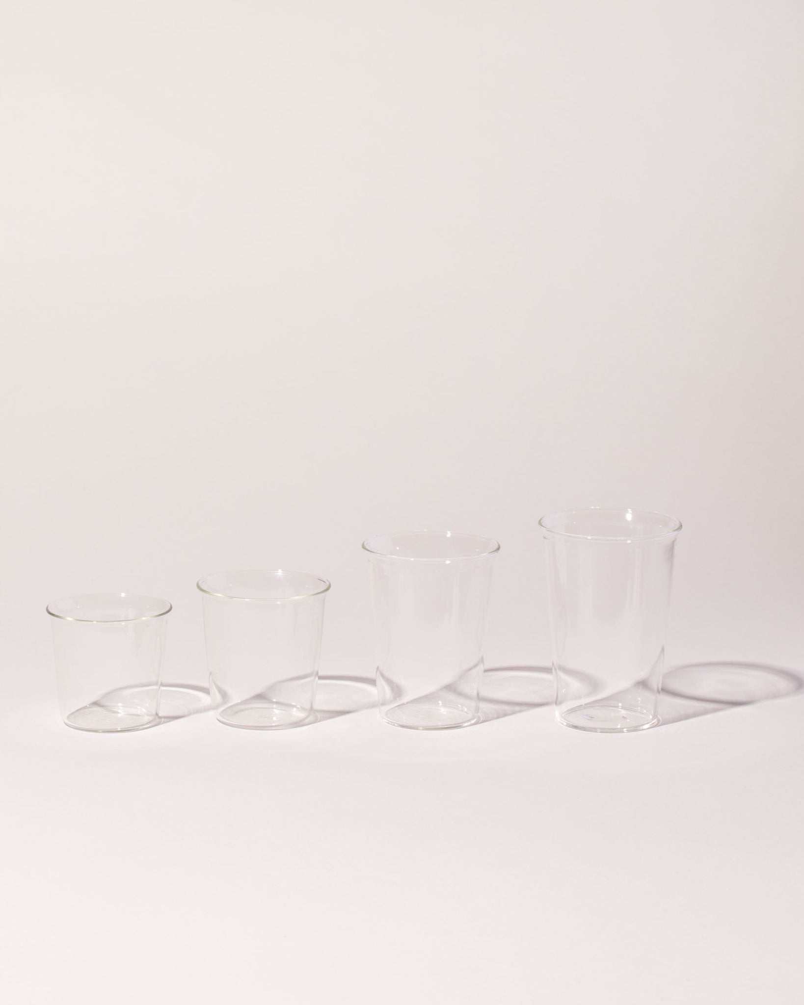 Kinto Collection amber glassware on a neutral-light background.