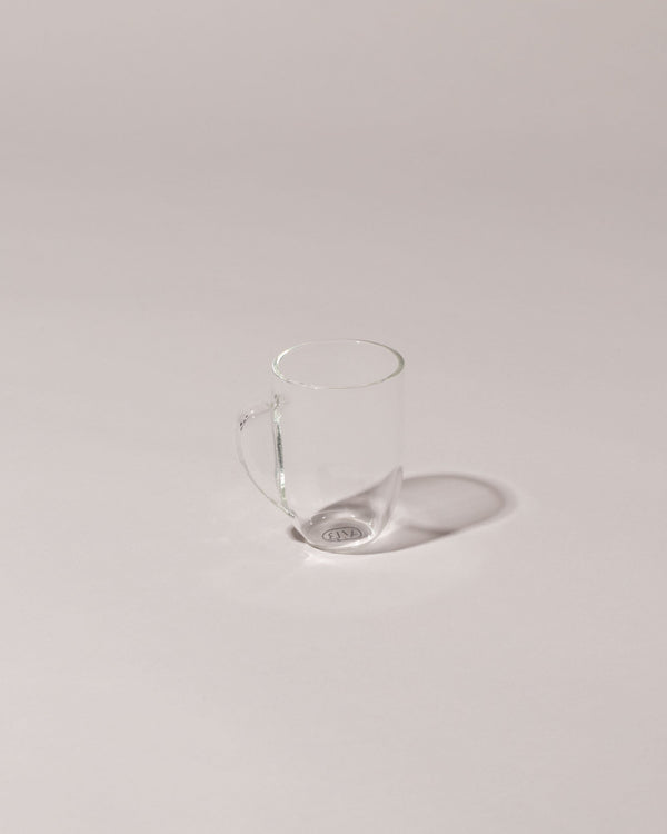 Laurence Brabant Collection clear glass Expansif Cup on a neutral-light background.