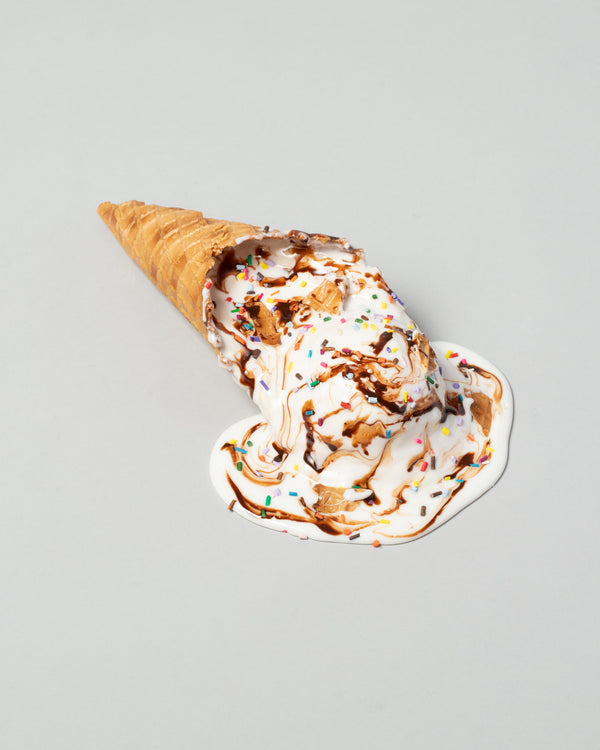 Spills Collection Waffle Cone ice cream spill with multicolored springkles, on a neutral-light background.