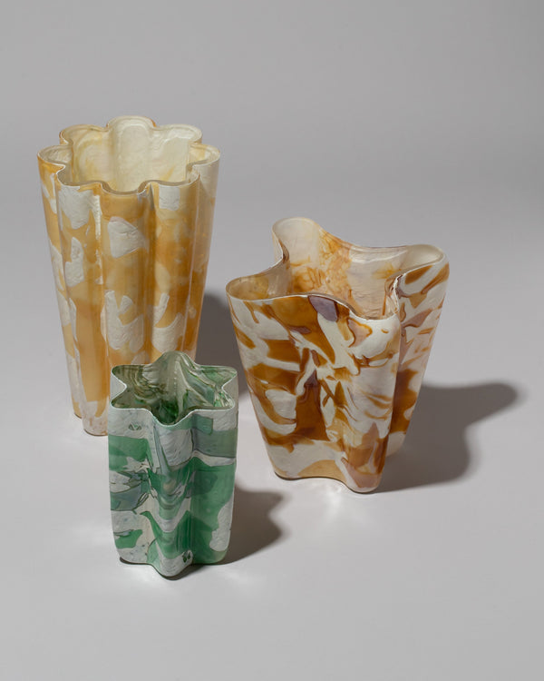 Stories of Italy Collection Nougat Bucket Vases in various sizes and colors, on a neutral-light background.