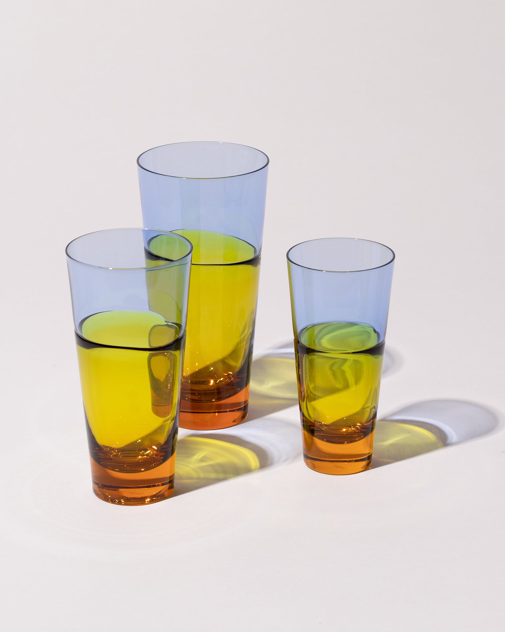 Sugahara Glassworks Collection glass Duo Tumblers with light blue, yellow and ochre details, on a neutral-light background.