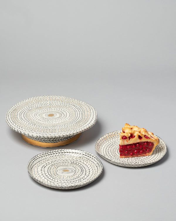 Suzanne Sullivan Collection Cake and Dessert plates with a slice of cherry pie, on a neutral-light background.