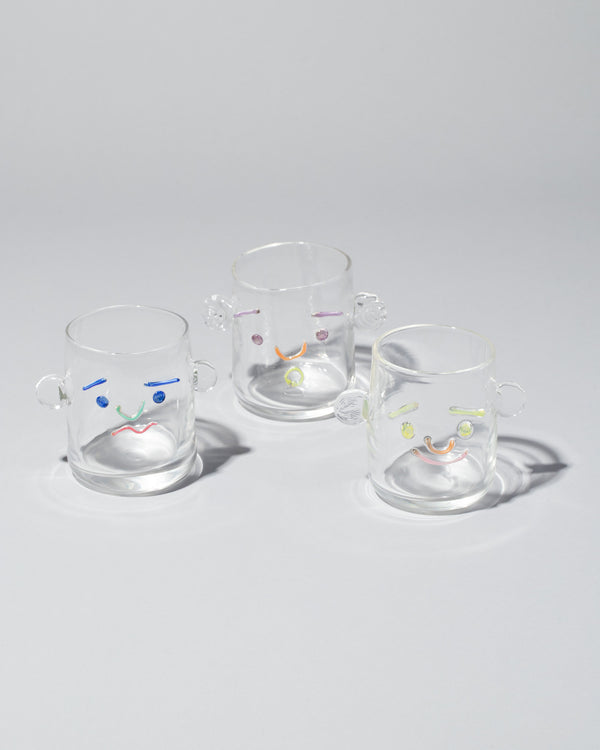 TAK TAK Collection glass Face Cups, on a neutral-light background.
