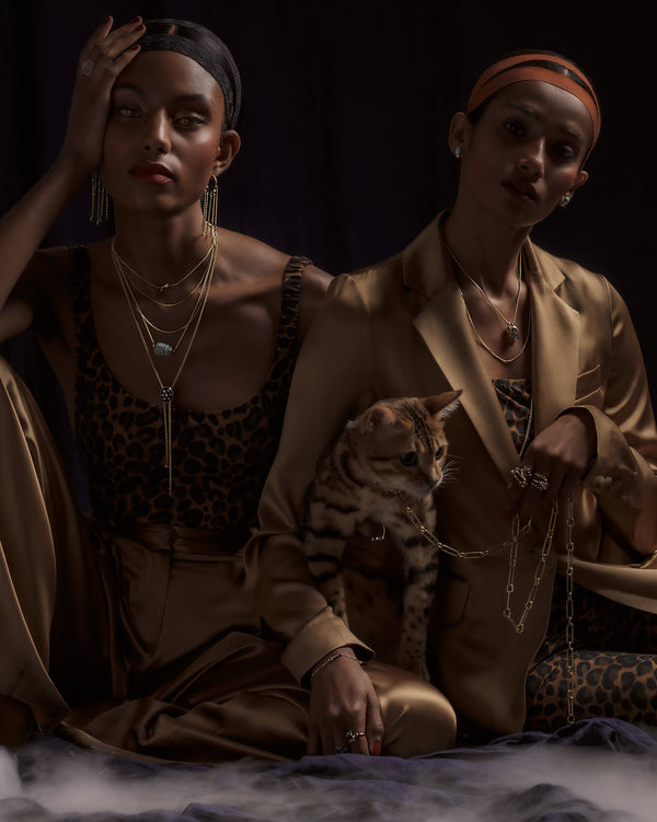 Photo of 2 models and a cat wearing jewelry from the Talismans Collection