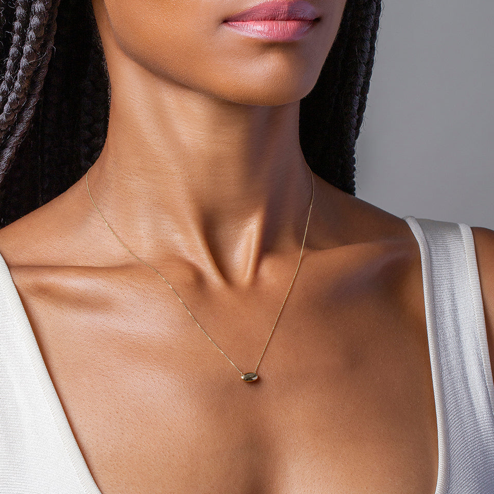 Mociun yellow gold Time Capsule Pendant and yellow gold chain on model.