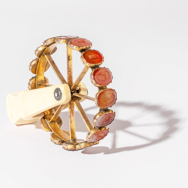 Styled image featuring an antique rotating wheel containing 16 doublets.