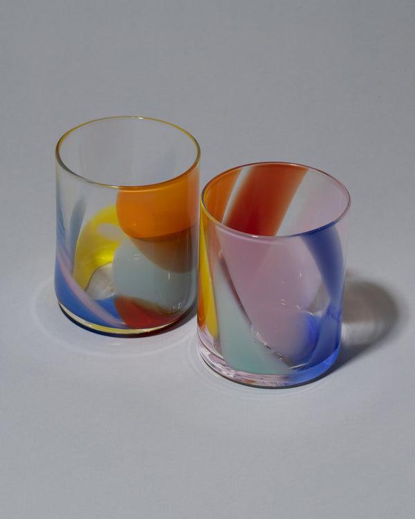Group image of Bow Glassworks Tutti Fruitti Splash Cup on light color background.