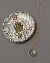 An Homage to Suzanne Pendant Necklace & Mini Dish on grey color background.