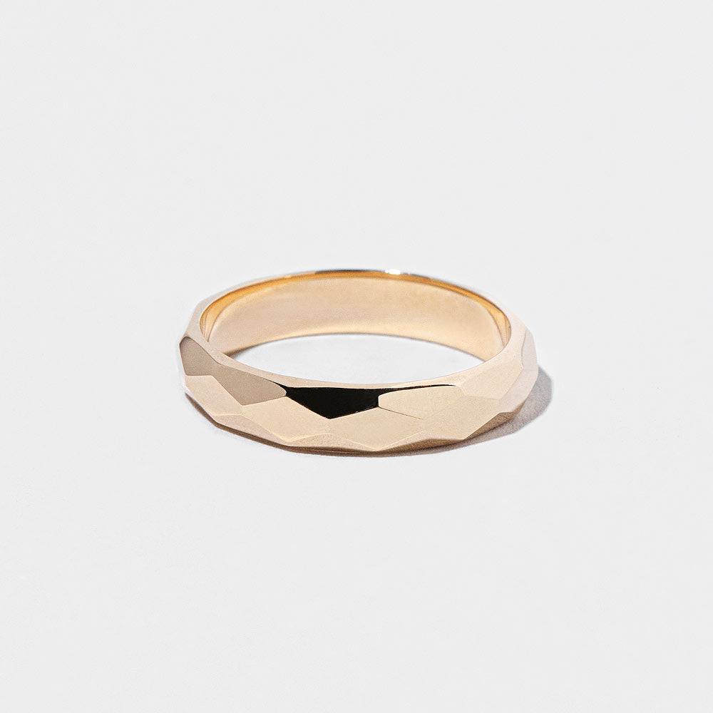 product_details::Gold 4mm Facet Band on light color background.