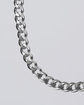 Silver Diamond Curb Chain on light color background.