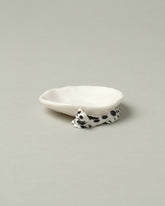 Closeup detail of the Eleonor Boström Black Spots Mini Cat Dish on light color background.