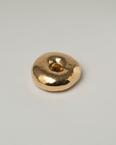 Pearce Objects Cast Bronze Los Angeles Bagel on light color background.