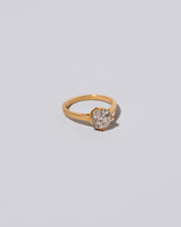 View from the side of the Super White Diamond Barragán Ring on light color background.