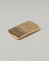 Closeup details of the Pearce Objects Cast Bronze Blackberry Curve on light color background.