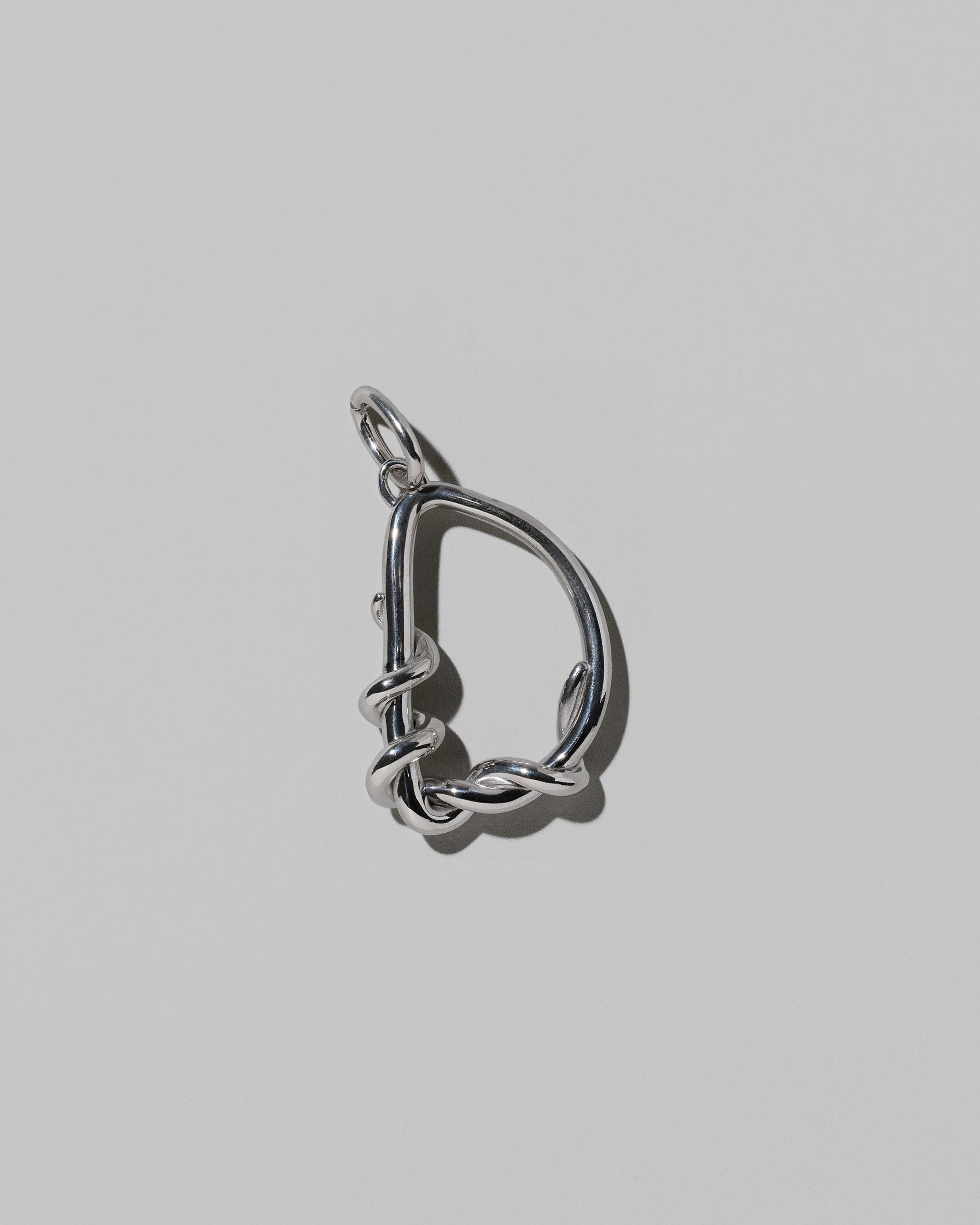 CRZM Sterling Silver Letter D Bag Charm on light color background.