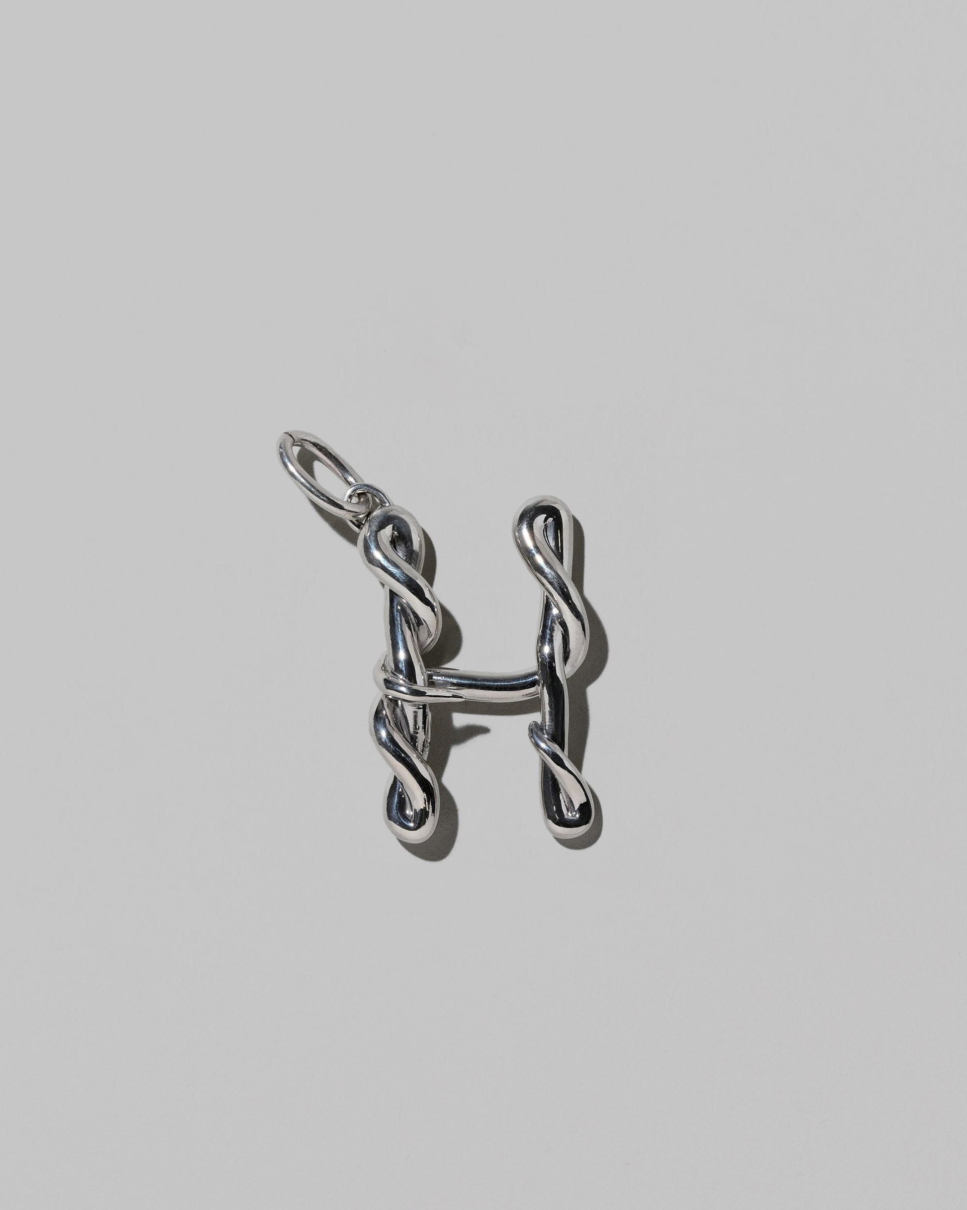 CRZM Sterling Silver Letter H Bag Charm on light color background.