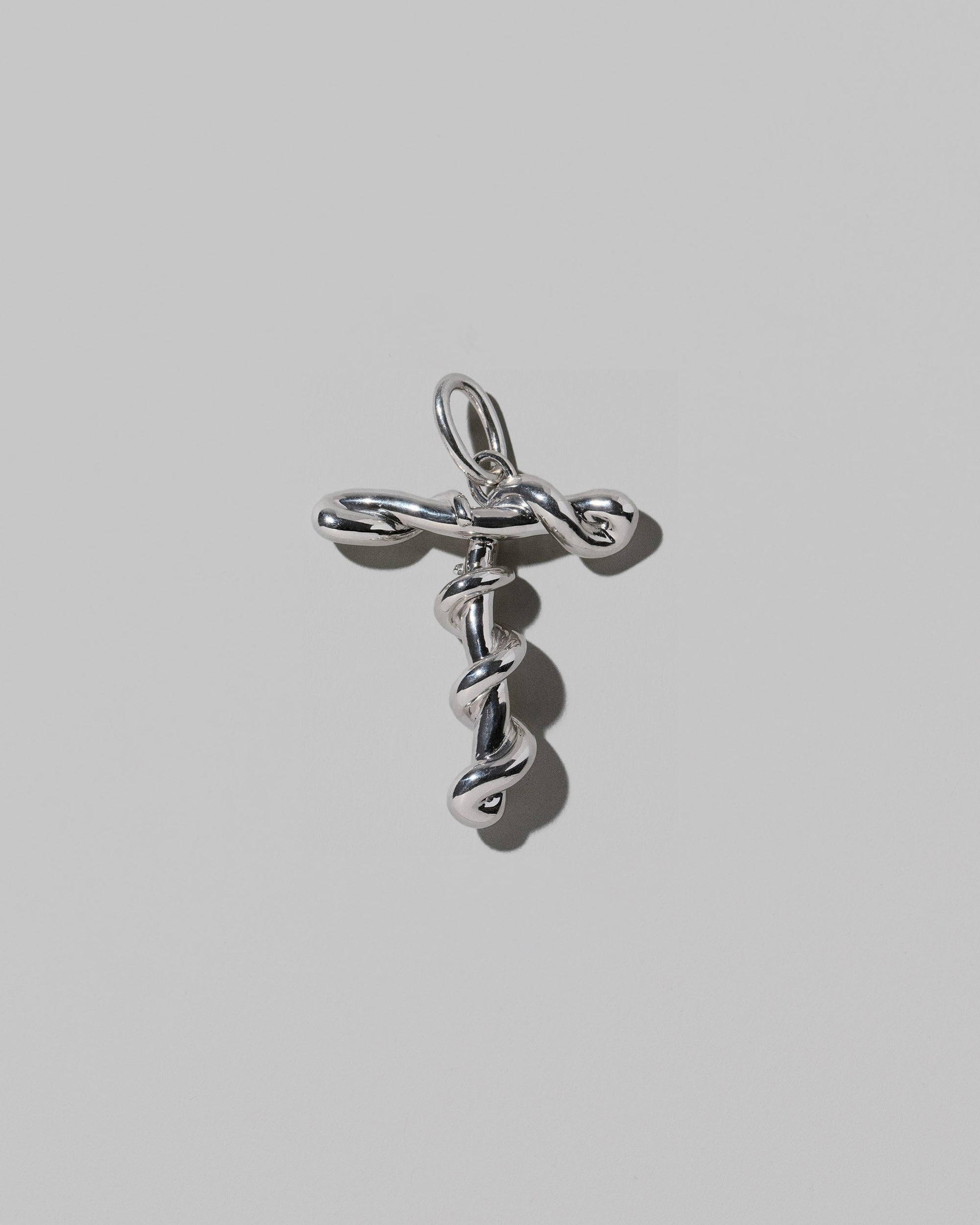 CRZM Sterling Silver Letter T Bag Charm on light color background.