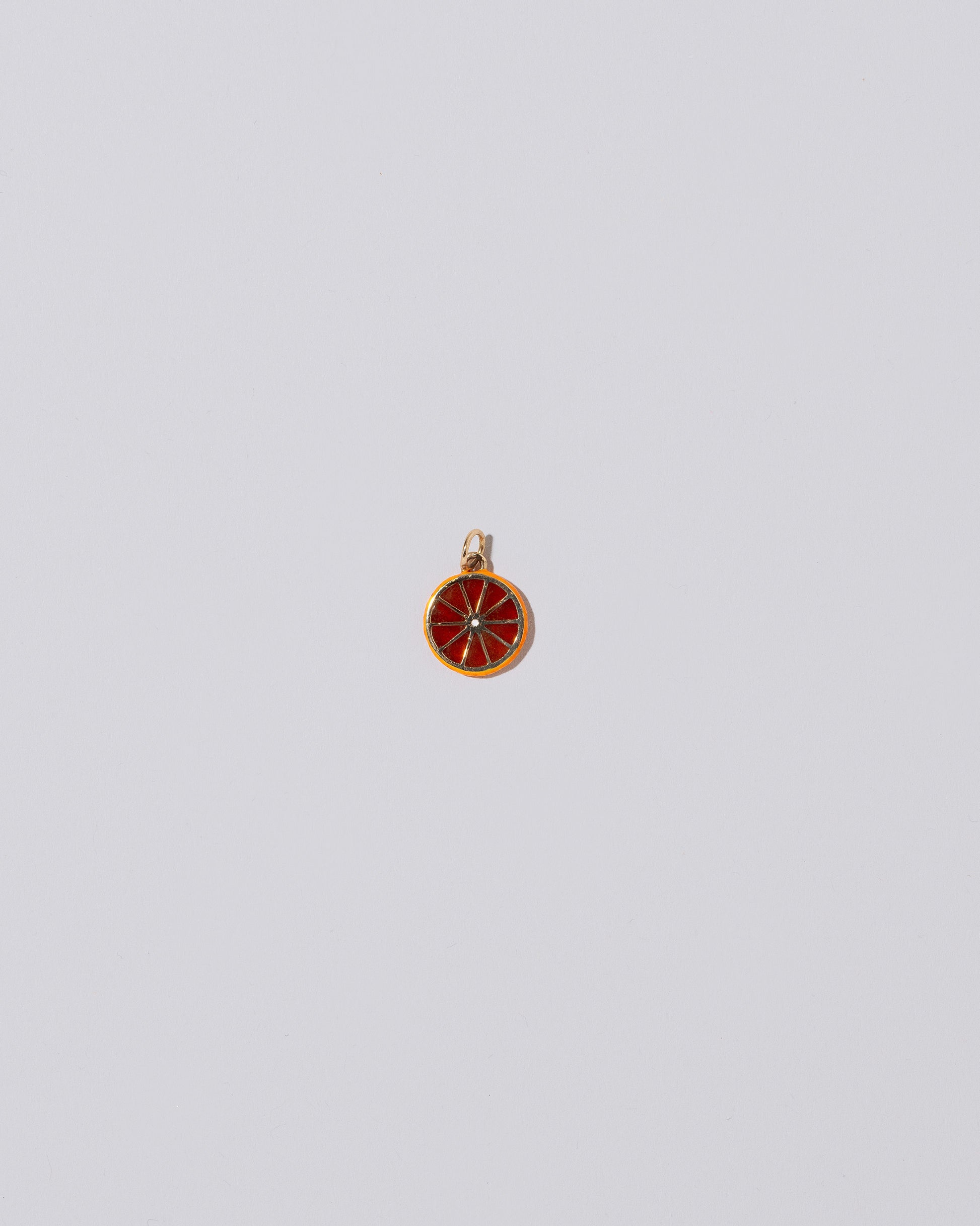 Large Sliced Fruit Charm - Tangerine on light color background.