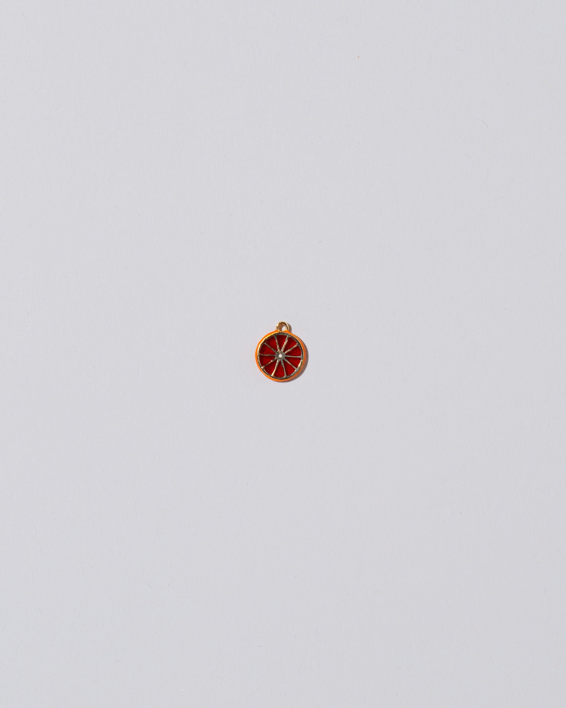 Small Sliced Fruit Charm - Tangerine on light color background.