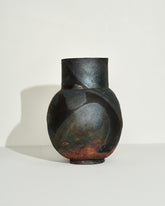 View from the back of the Emily Mullin Indigo Raku Vessel IV on light color background.