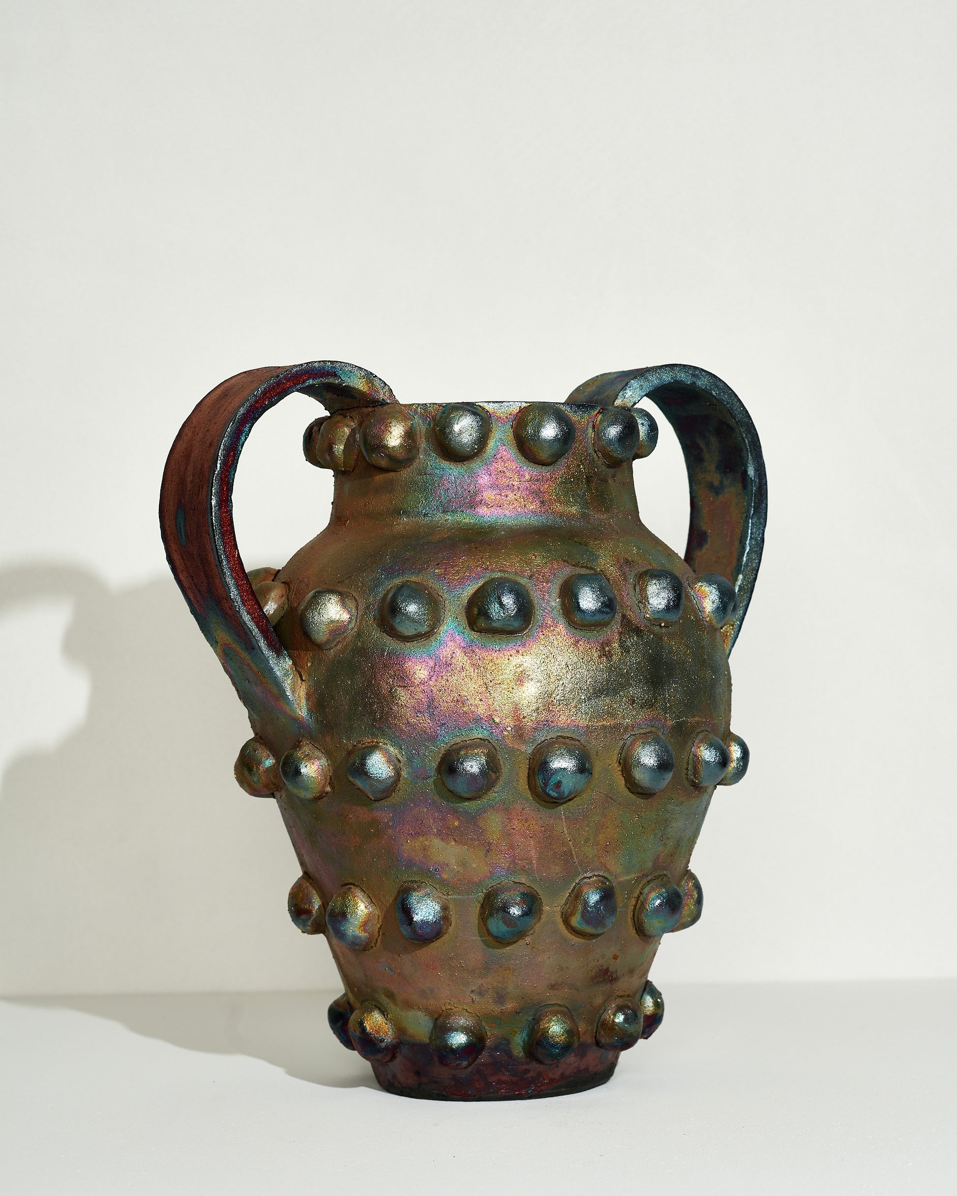 Emily Mullin Urn With Balls on light color background.