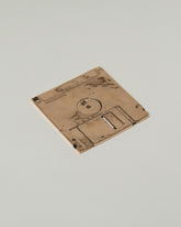 Pearce Objects Cast Bronze Floppy Disk on light color background.