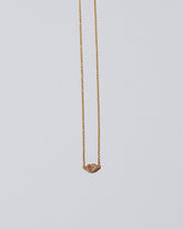 Light Pink Big Kiss Necklace on light color background.