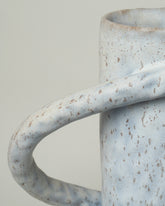 Closeup details of the Giselle Hicks Speckled Pale Grey Oval Vessel with Handles on light color background.