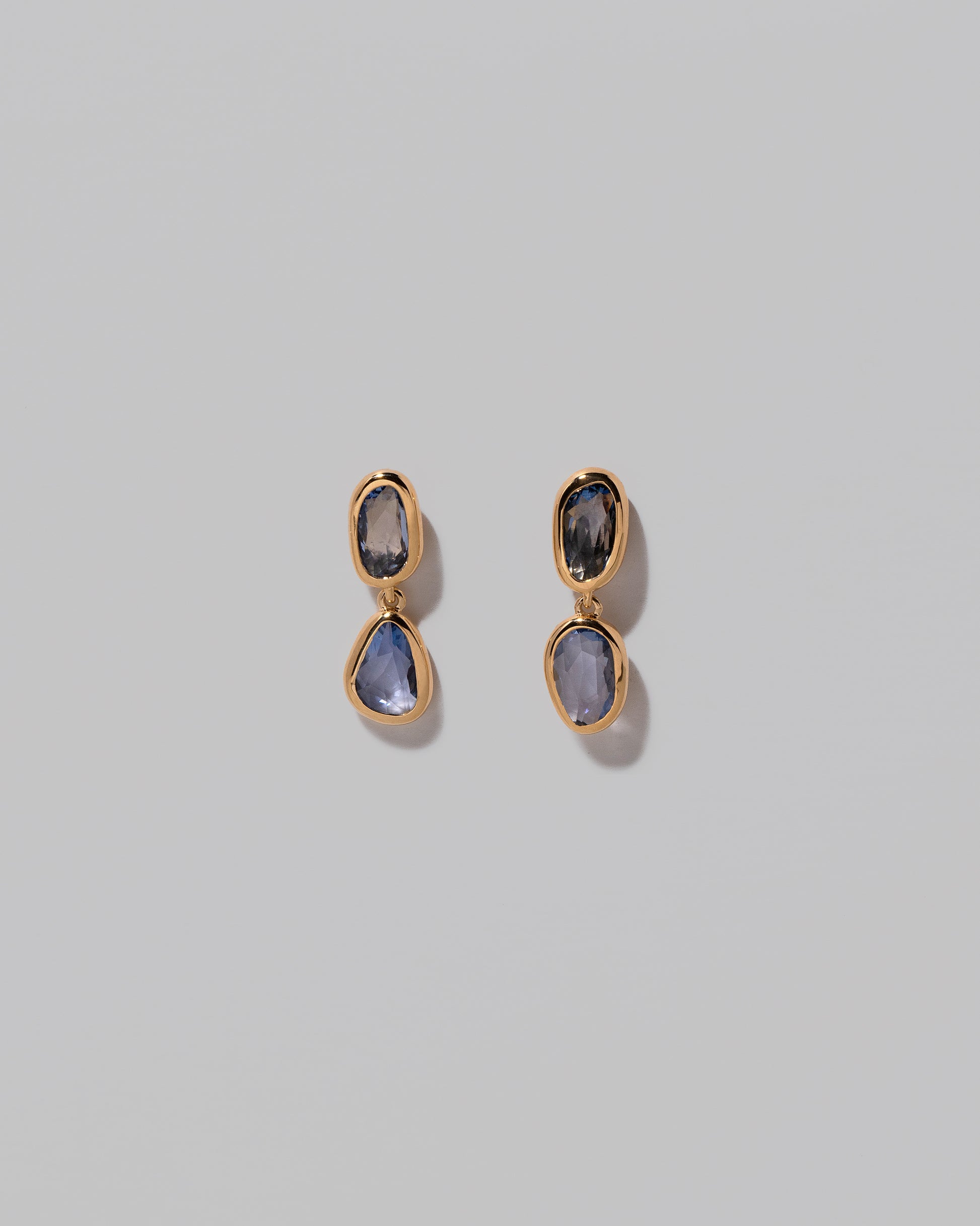 Gusher Blue Sapphire Drop Earrings 001 on light color background.