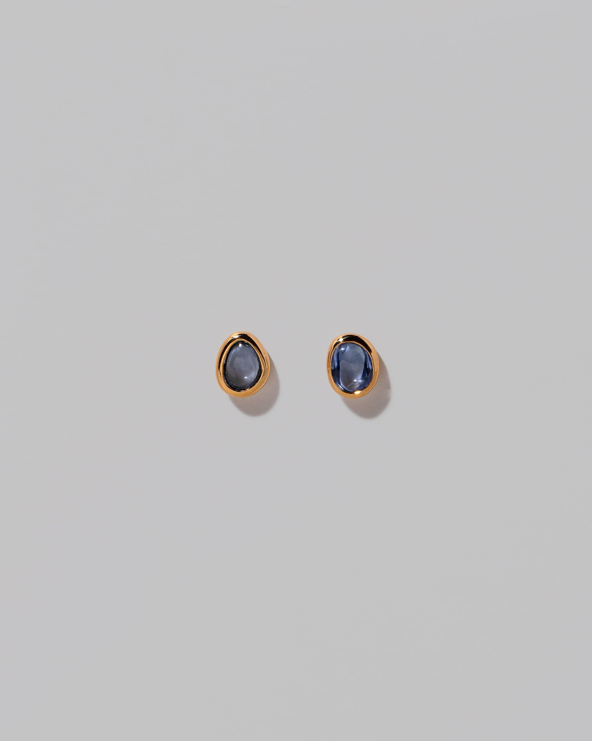 Gusher Blue Sapphire Stud Earrings 002 on light color background.