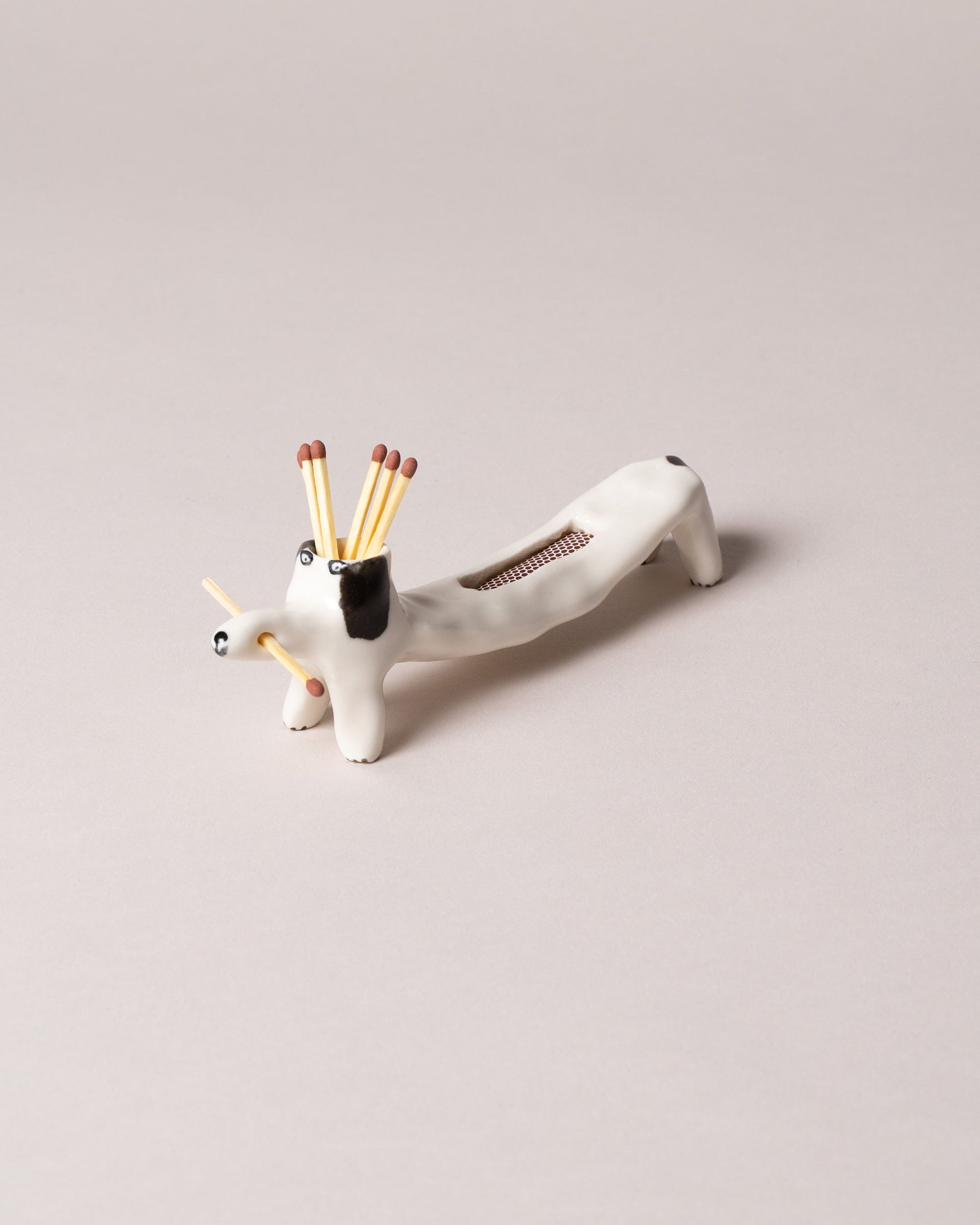Eleonor Boström Black Matchstick Dog on light color background.