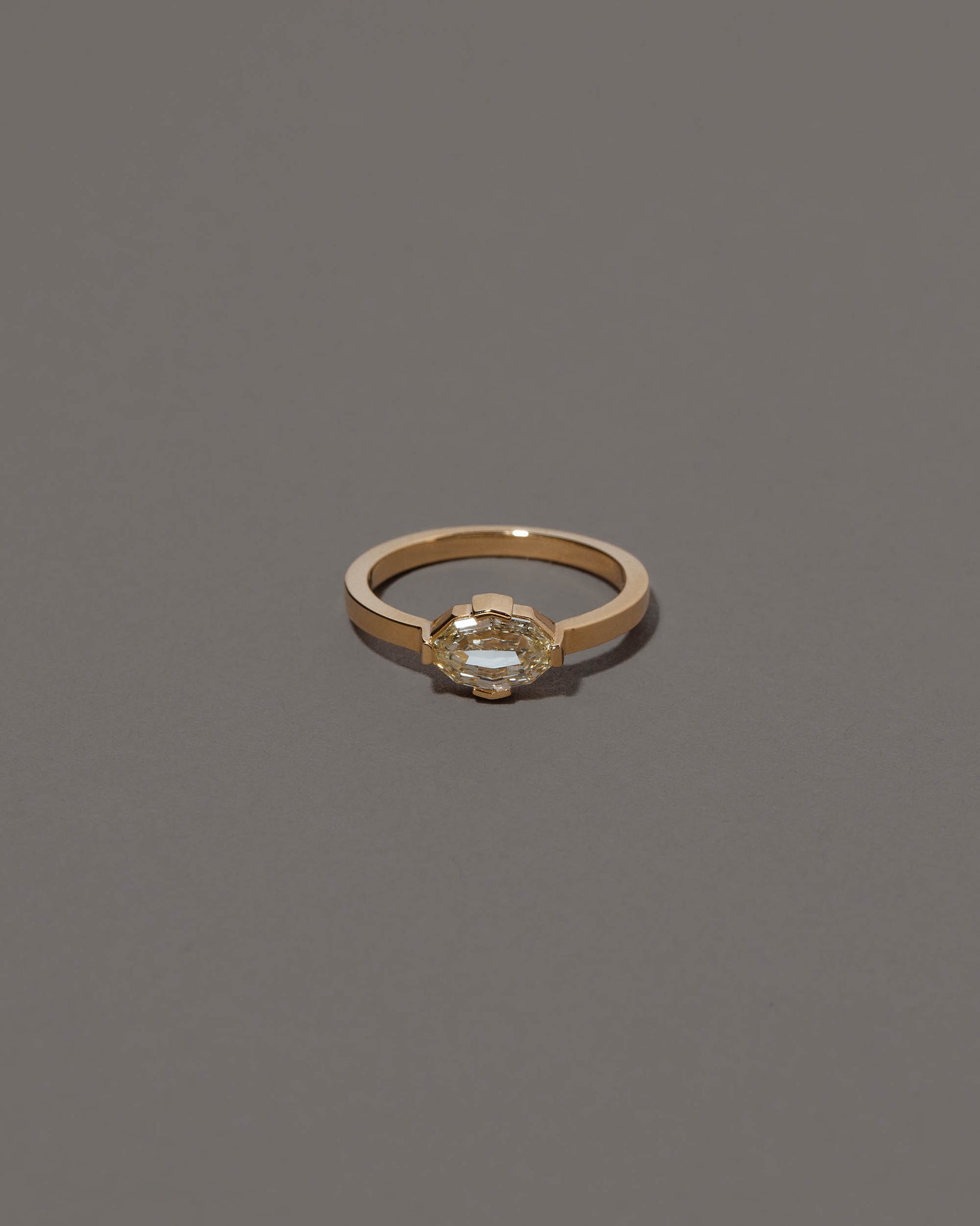 Beholden Ring on grey color background.
