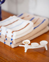 Styled image featuring the Eleonor Boström White Baggage Dog Baggage Dog and Gold White Diamond Low Tide Band.