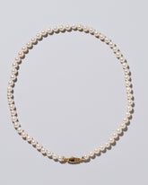 Closeup detail of the Blue Pearl & White Gold Union Pearl Necklace on light color background.