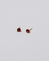 Mega Red Garnet Martini Stud Earrings on light color background.