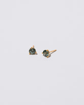 Mega Teal Sapphire Martini Stud Earrings on light color background.