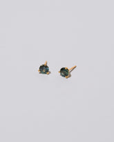 Mega Blue Sapphire Martini Stud Earrings on light color background.