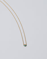 Eye See You Necklace on light color background.