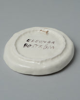 View from the back of the Eleonor Boström Hanging Dog Dish on light color background.