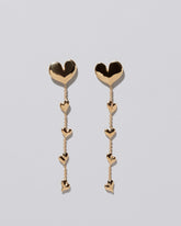 Gold Thousand & One Night Heart Shoulder Duster Earrings on light color background.