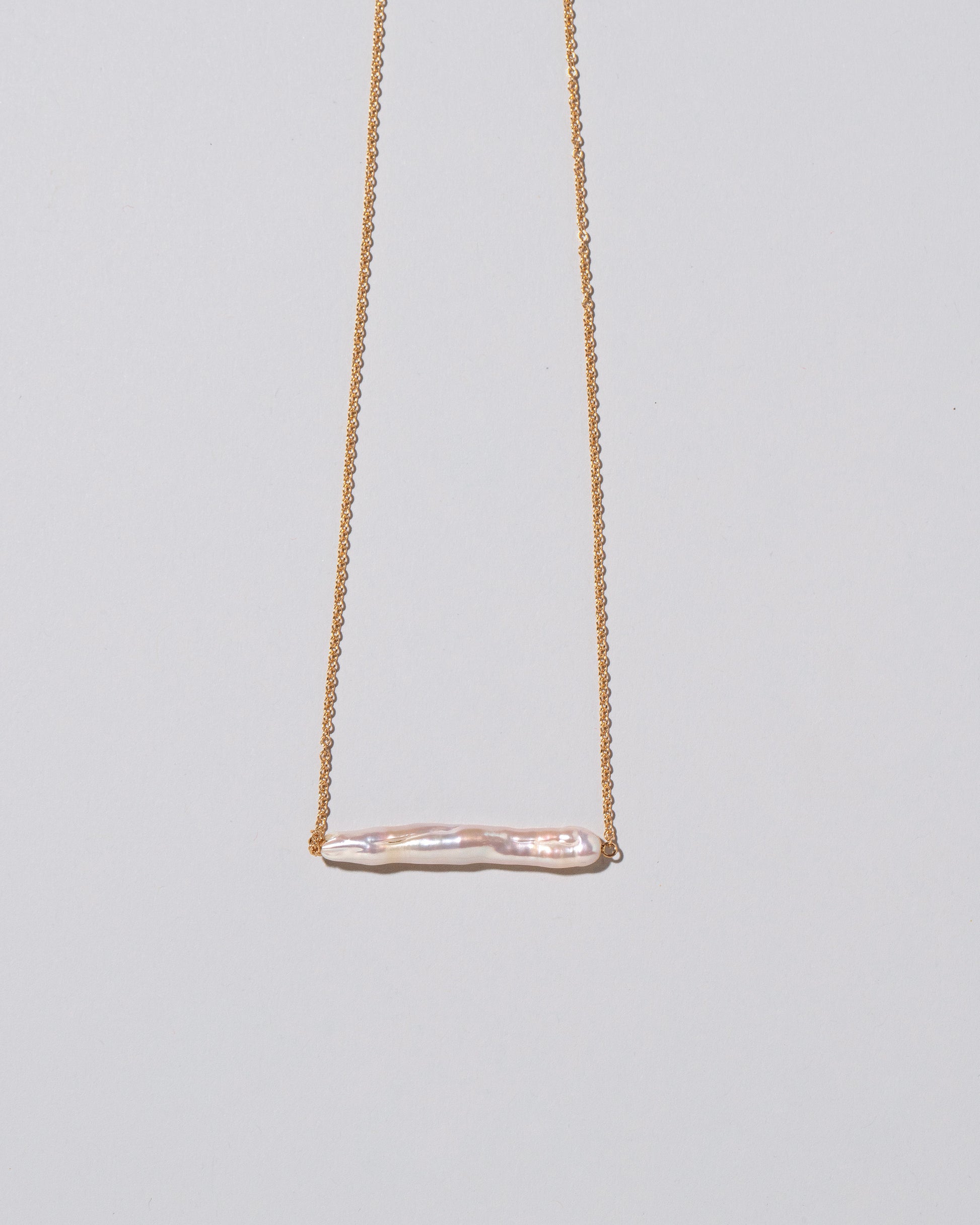 Stick Pearl Necklace on light color background.