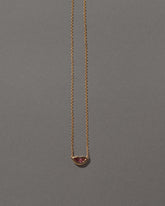 Peach Spinel Lover's Kiss Necklace on grey color background.