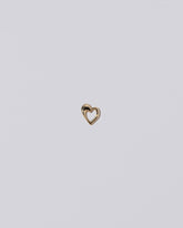 Thousand & One Night Heart Charm on light color background.