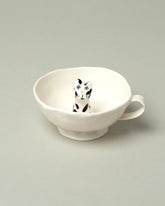 Closeup detail of the Eleonor Boström Black Spots Cat Cup on light color background.