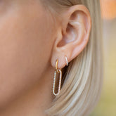product_details::Pavé Link Huggie Hoop Earrings on model.