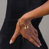 product_details::Avocado Charm, Asparagus Charm, Carrot Charm and Long Loop Chain Bracelet on model.