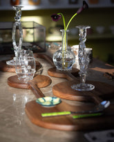 Styled image featuring the Lucas Castex No. 02 Hand-Carved Walnut Wood Serving Board.