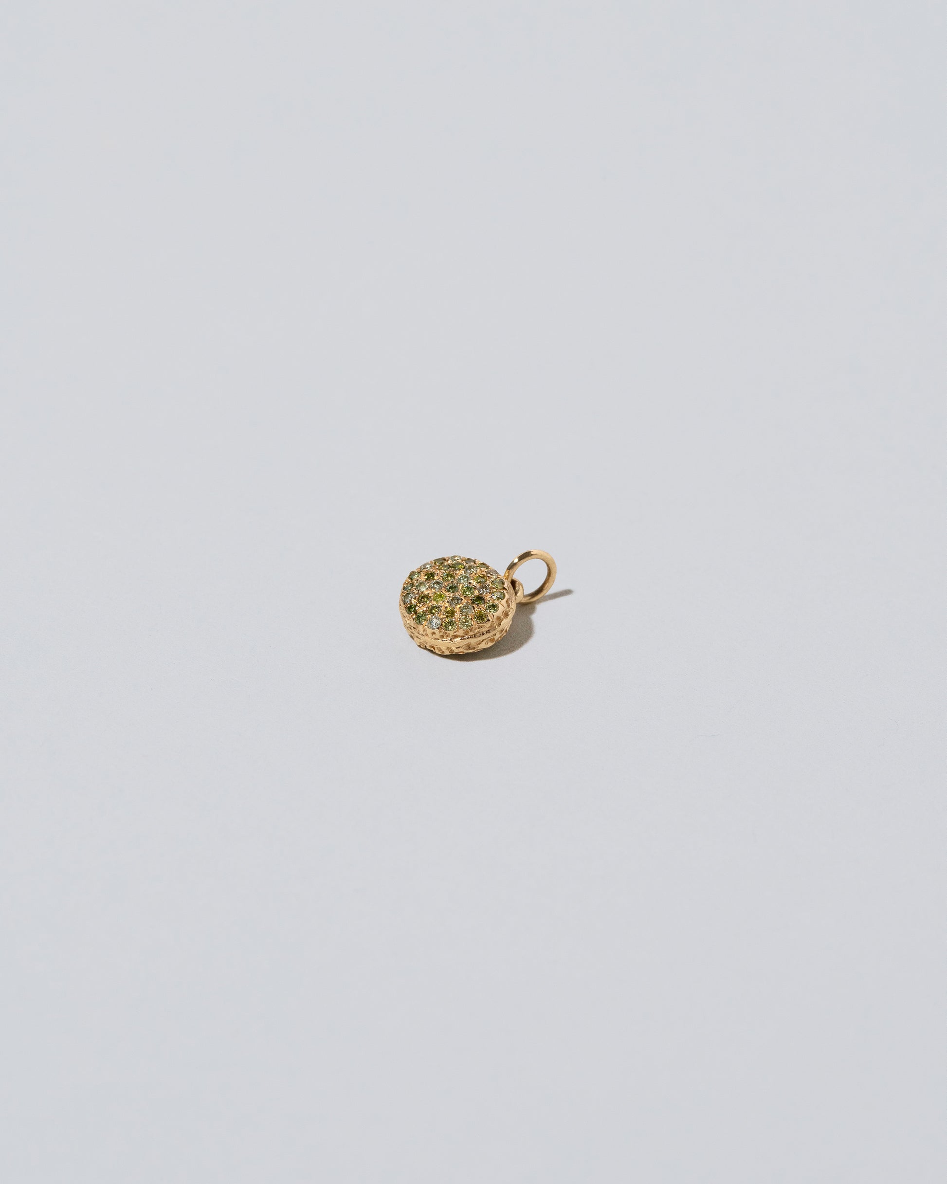 Mini Macaron Charm - Diamond Pavé Pistachio on light color background.